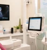 Dentist using modern digital equipment during a comfortable, pain-free root canal procedure